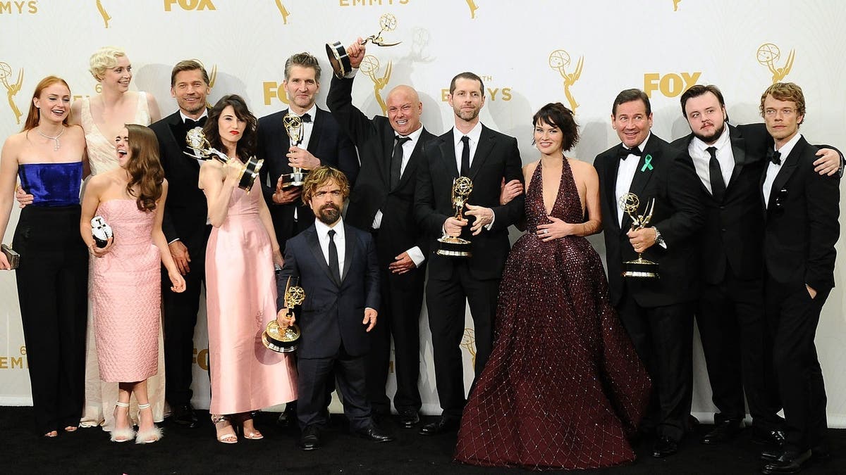 Sophie Turner and cast pose in the press room at the Emmy Awards.