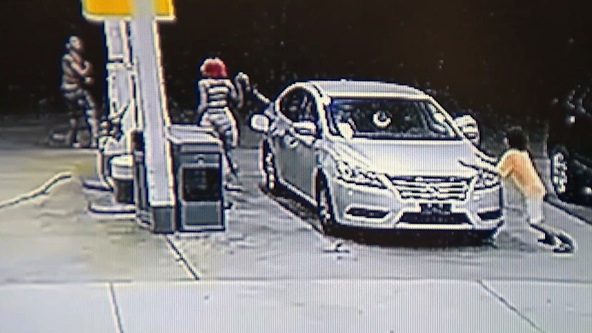 Surveillance video shows a mother pumping gas beside her family's car at a Shell station moments before police say an attempted child abduction unfolded.