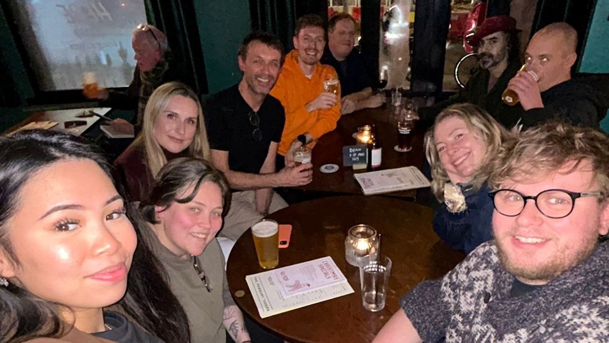 Dean Perryman sits with a group of strangers at the bar.