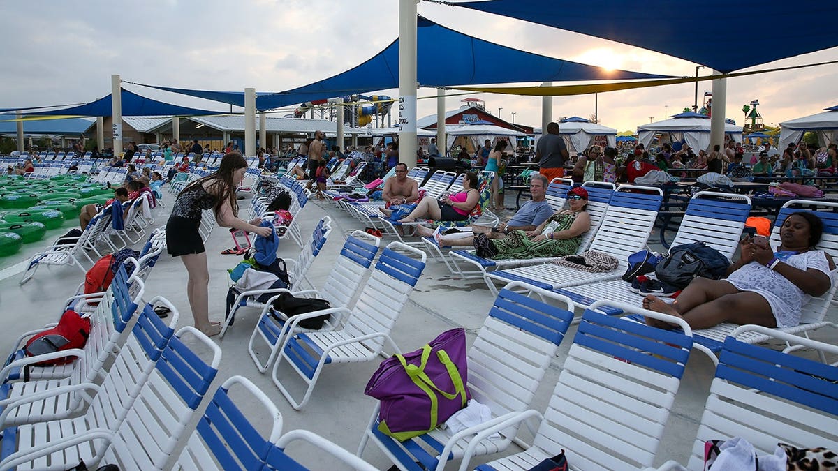 guests laying pool chairs