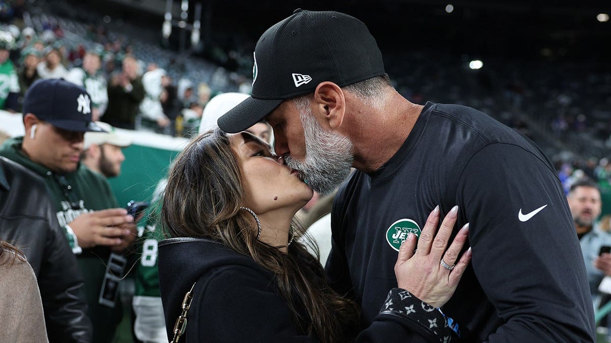 Jeff Ulbrich and his wife Cristina embrace before a Jets game at MetLife Stadium.