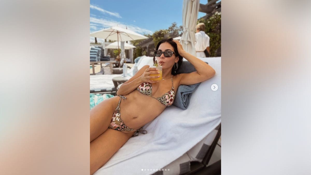 Jenna Dewan lounging in a multi-color bikini.
