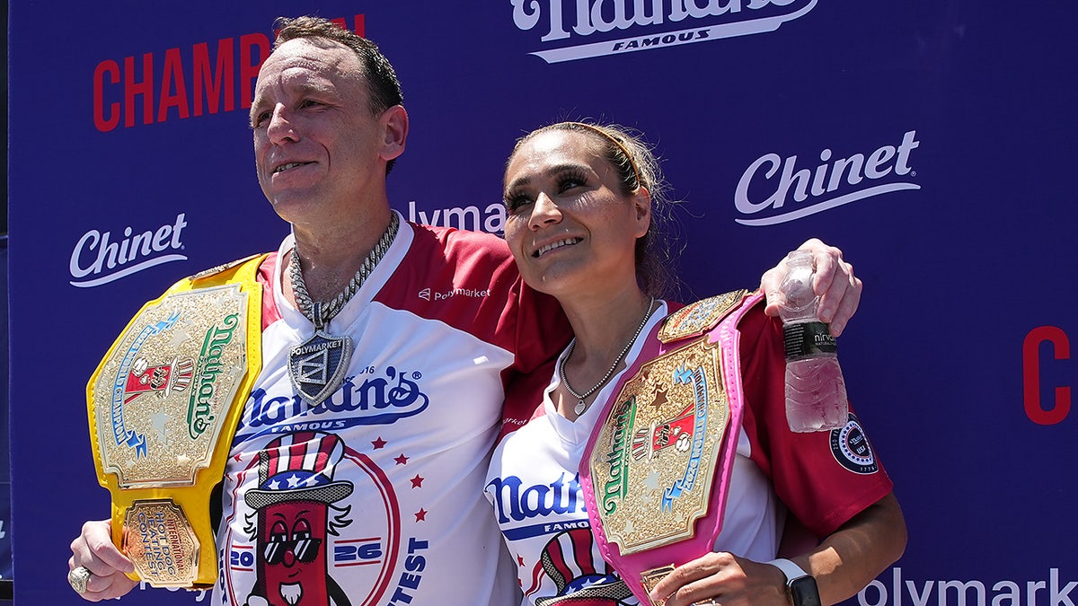 Joey Chestnut and Miki Sudo, winners of the 2026 Nathan's Famous Fourth of July hot dog eating contest, hold their title belts at Coney Island in the Brooklyn borough of New York, Saturday, July 4, 2026.