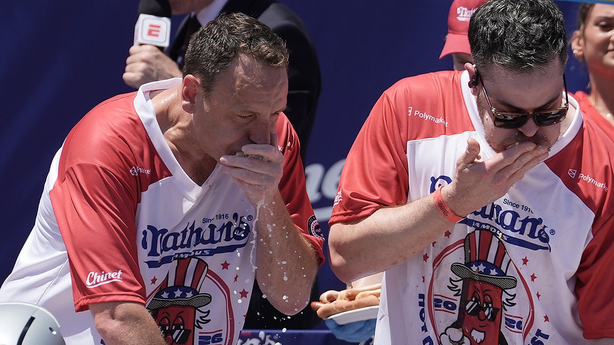 Joey Chestnut and other competitive eaters consume hot dogs during the 2026 Nathan's Famous Fourth of July hot dog eating contest at Coney Island, July 4, 2026.