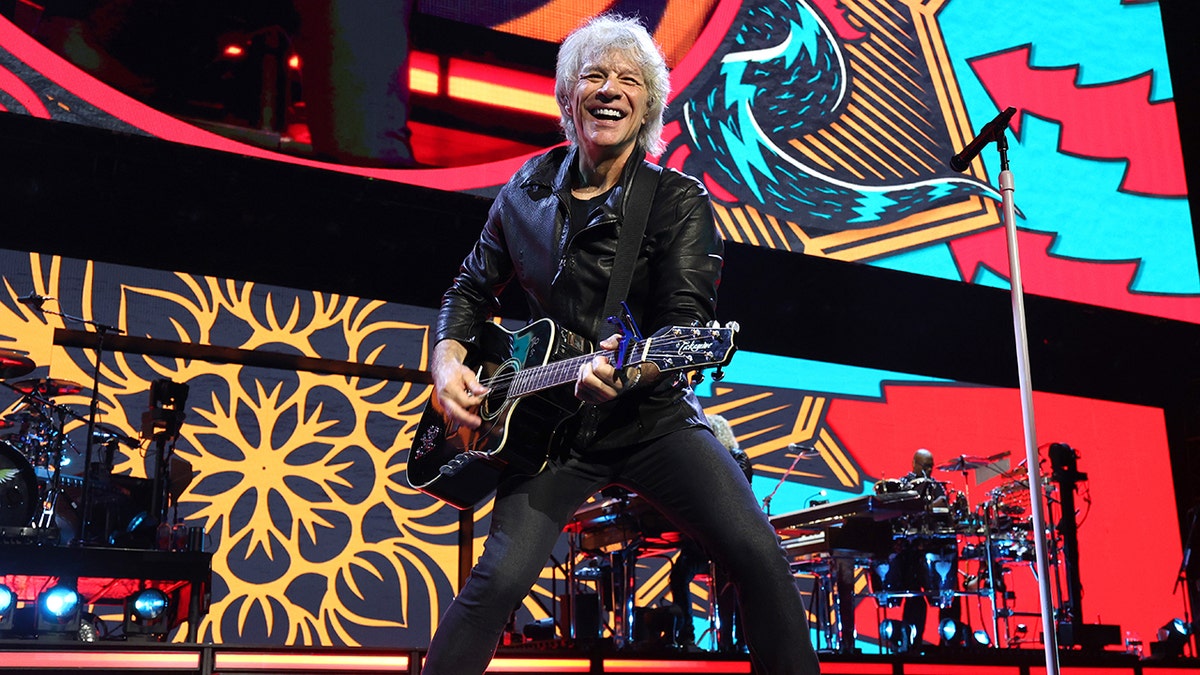 Jon Bon Jovi plays guitar