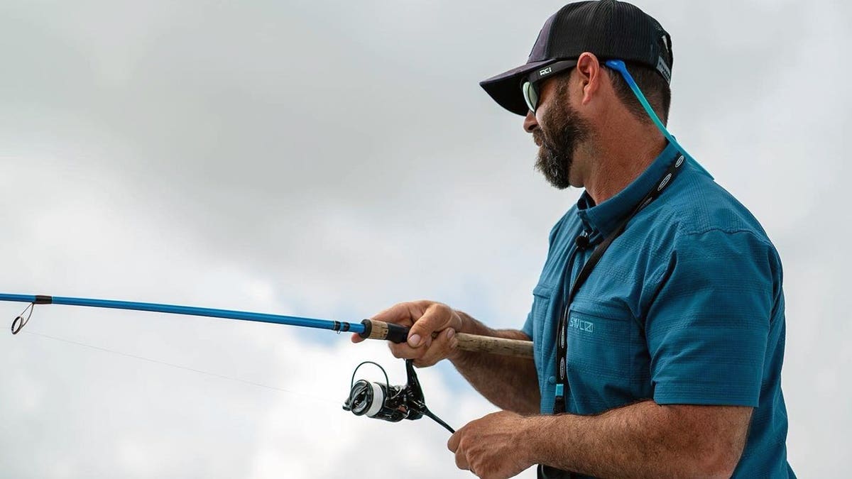side view of man with a fishing pole