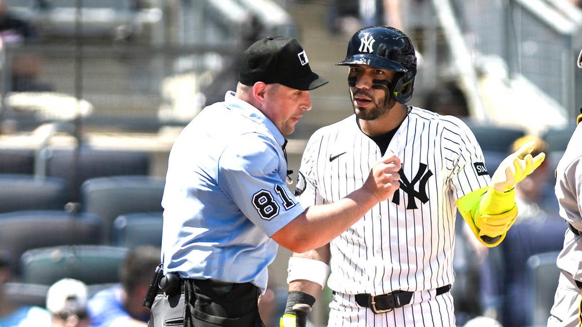 Jose Caballero reacts after being called for a clock violation at Yankee Stadium.