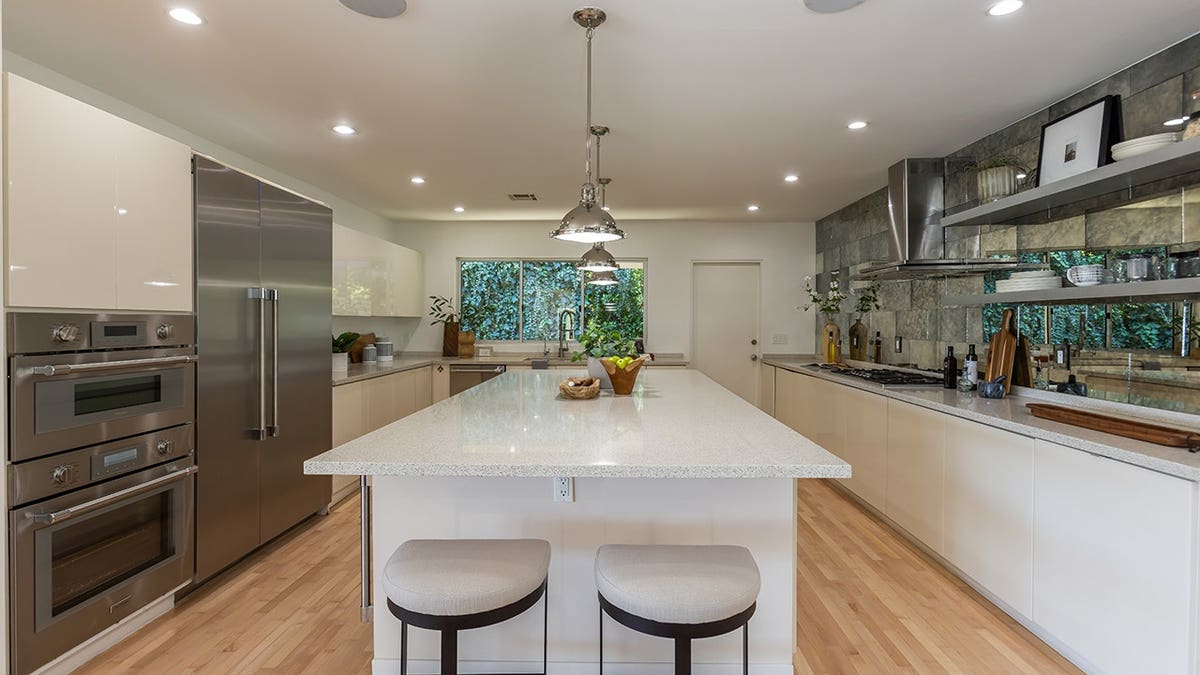 A kitchen with all-white countertops and a center island.