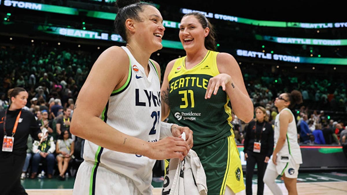 Kayla McBride and Stefanie Dolson talk after a WNBA game.
