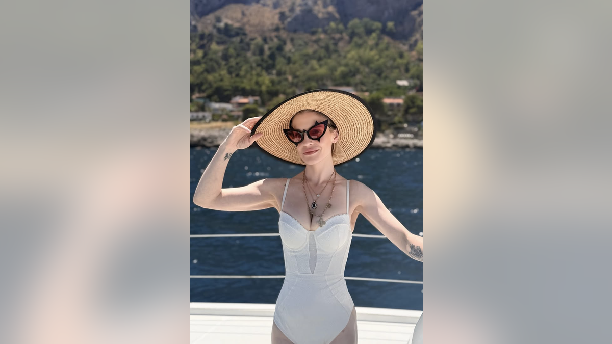Kelly Osbourne in white swimsuit