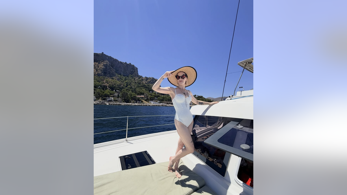 Kelly Osbourne in white swimsuit on the yacht
