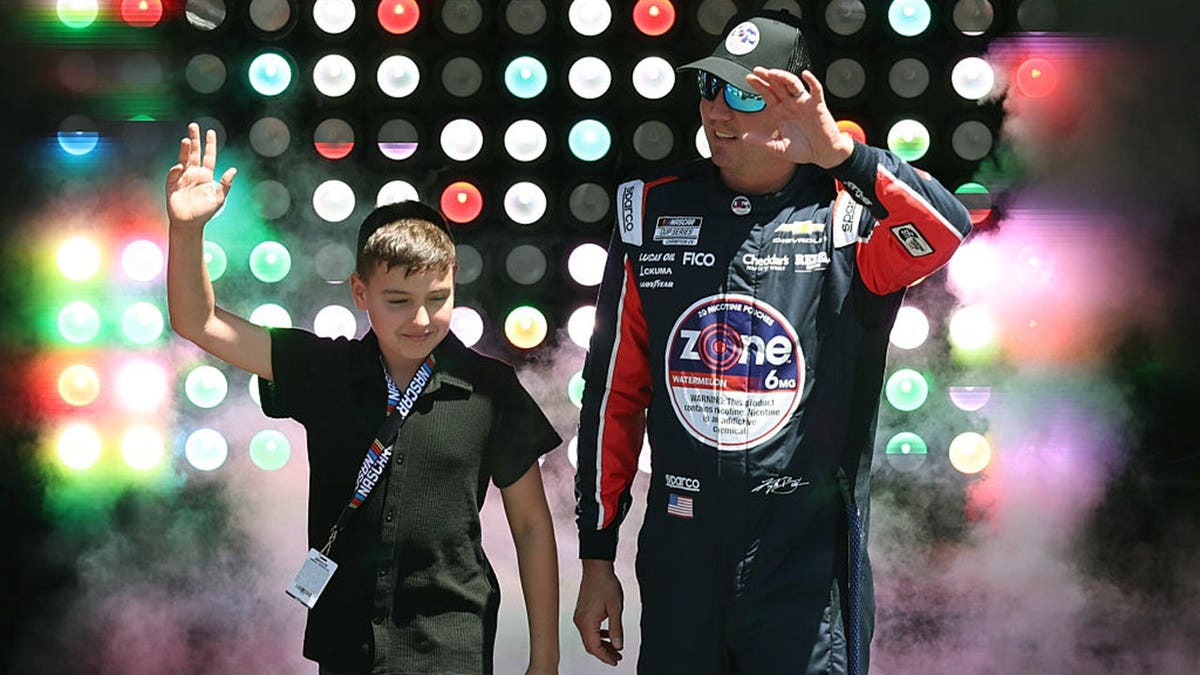 Kyle Busch stands near his car at Texas Motor Speedway.