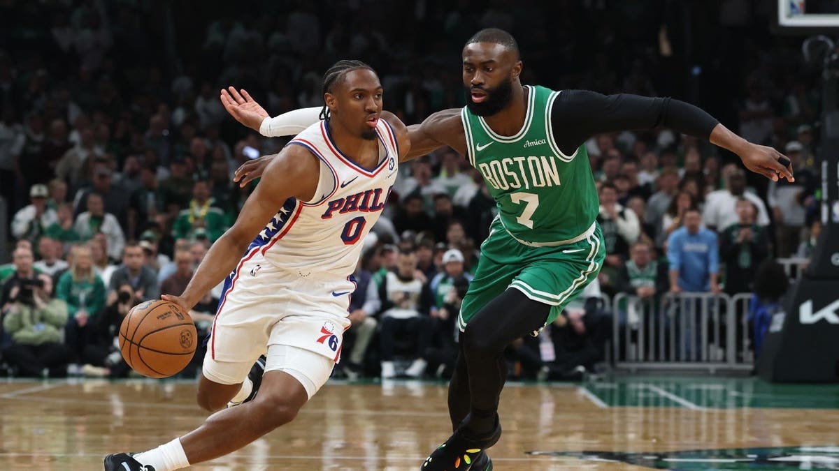 Philadelphia 76ers SG Tyrese Maxey drives past former Boston Celtics wing Jaylen Brown during Game 7 of the first round of the 2026 NBA Playoffs at TD Garden.