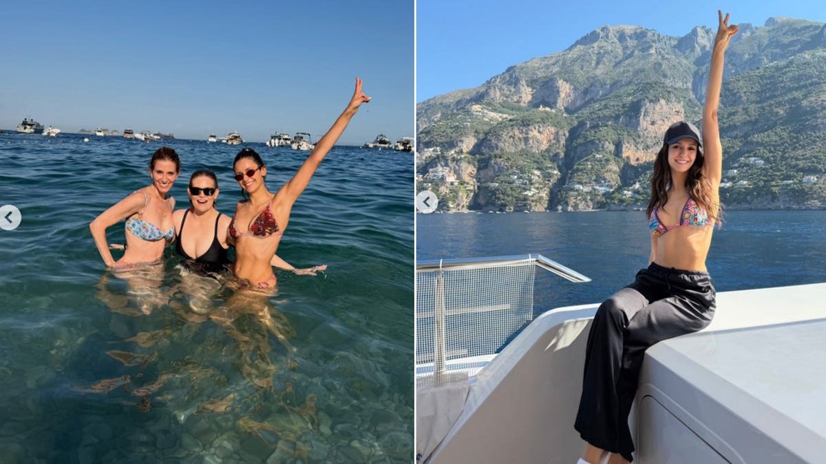 Nina Dobrev posing with her arms in the air with her friends.
