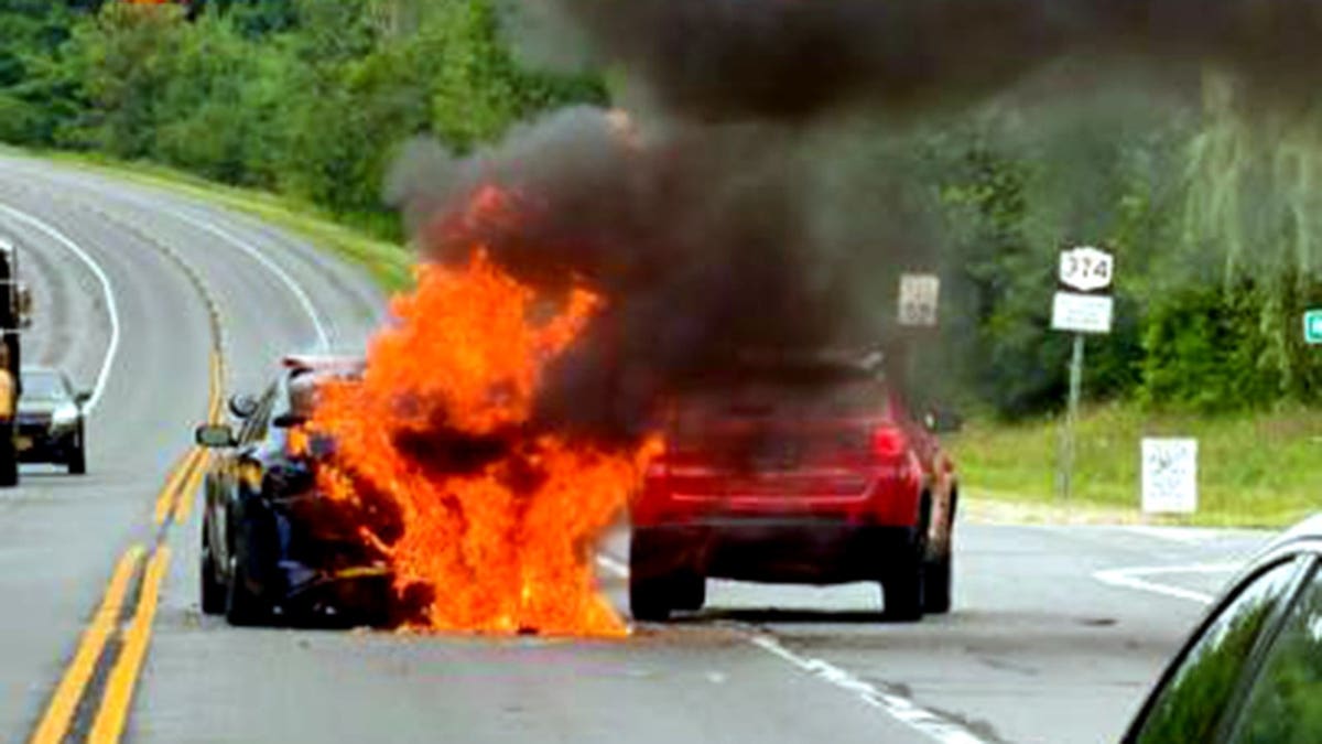 flames engulfing patrol vehicle