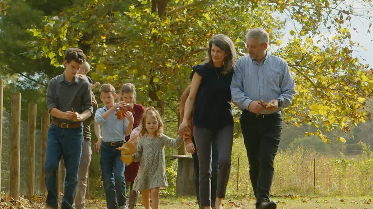 Paul Vaughn walking with his wife and children