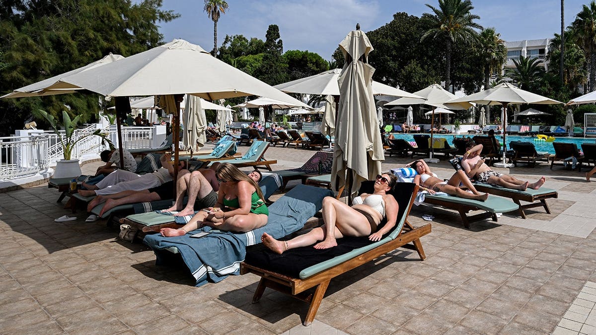people laying pool chairs
