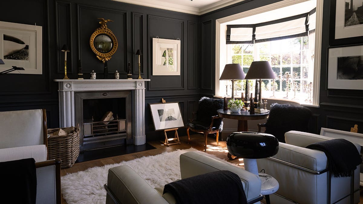 An office space with a fireplace and green walls.