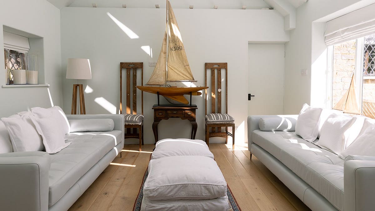 A sitting room with white couches.