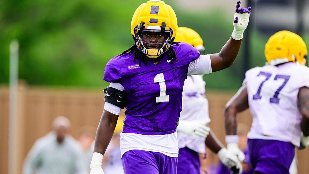 Princewill Umanmielen, wearing LSU Tigers No. 1, celebrates during spring practice.