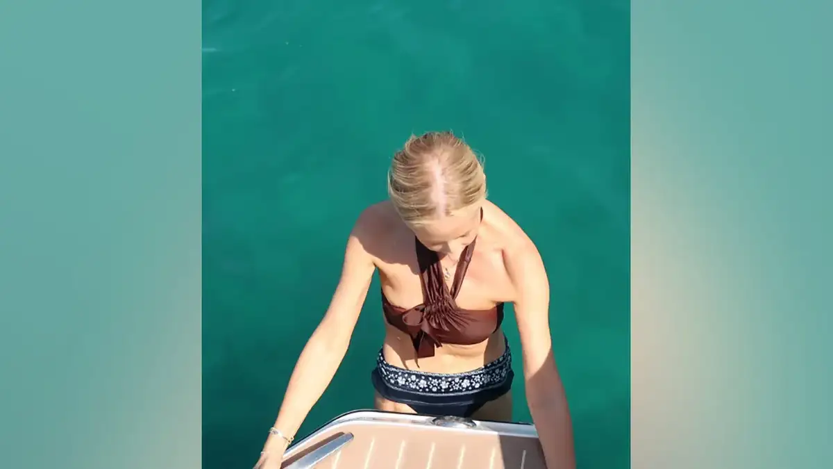 Sarah Michelle Gellar climbs a ladder onto a boat after swimming in the Mediterranean while wearing a brown bikini top and patterned bikini bottoms during her South of France getaway.