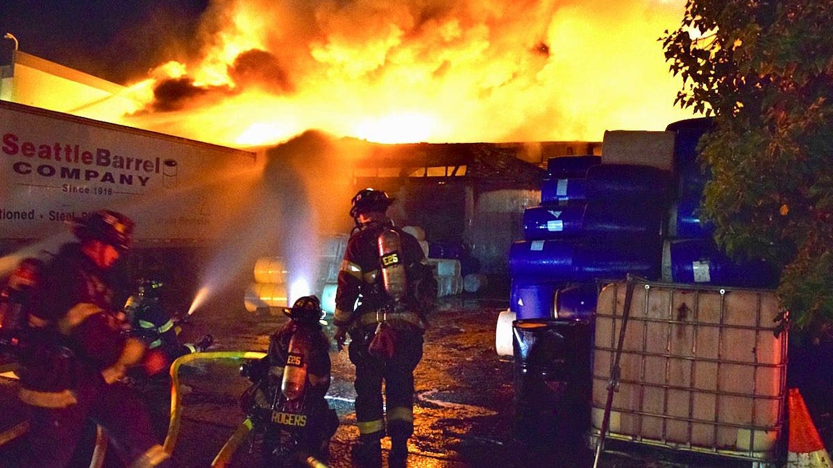 Firefighters in front of a fire