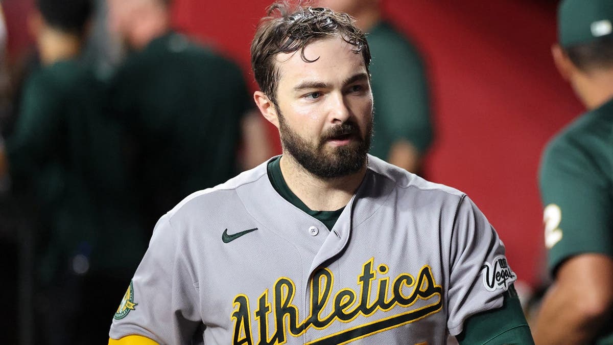 Shea Langeliers sits in the dugout after hitting a solo home run.