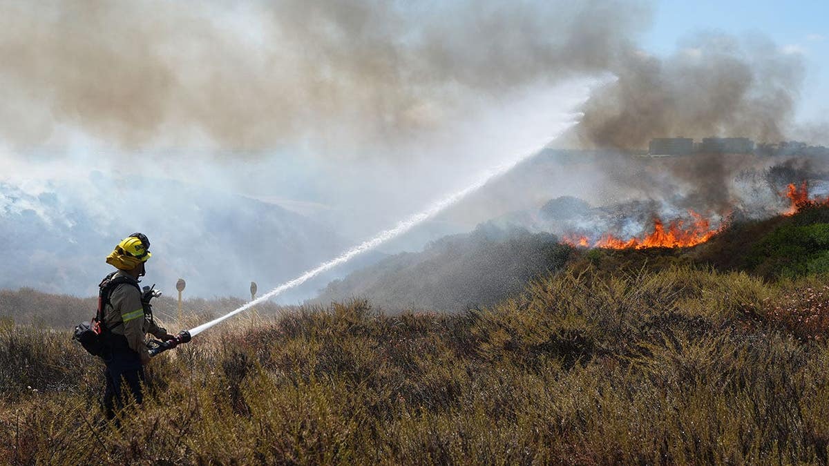 Smoke billows over Sorrento Valley as firefighters battle the Sorrento Fire.
