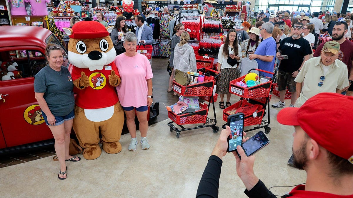 Customers stand in line with the Buc-ee's mascot in Mount Crawford, Virginia.