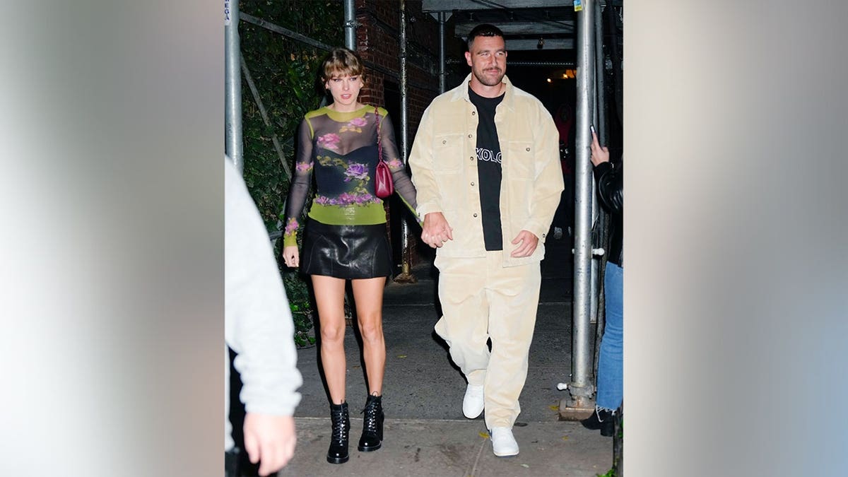 Travis Kelce and Taylor Swift holding hands in New York in October 2023.