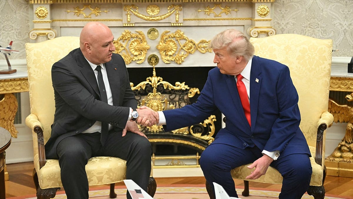Donald Trump shakes hands with Joseph Aoun in the Oval Office.