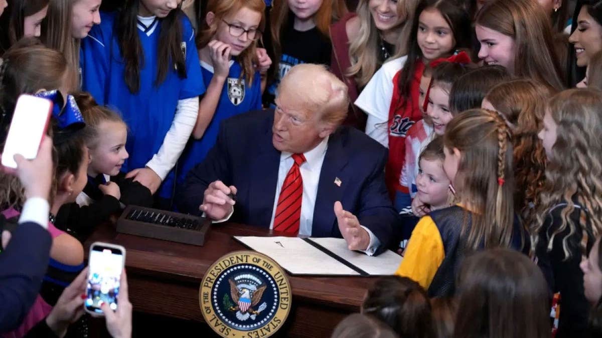U.S. President Donald Trump signs the