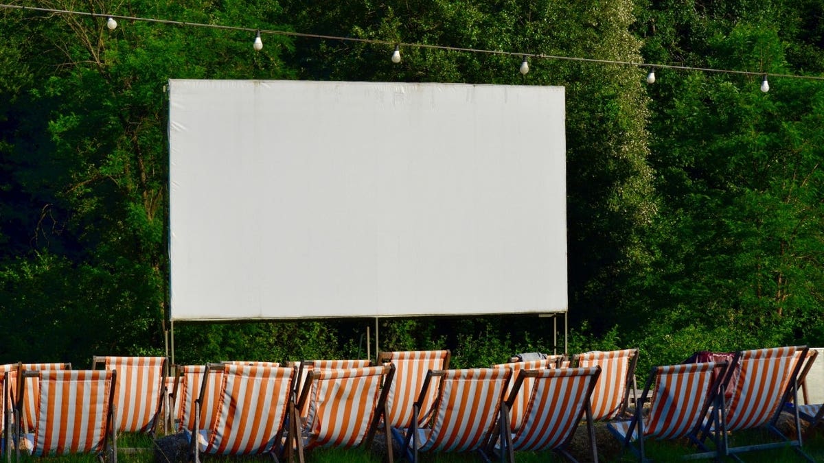 A projector with chairs in front of it