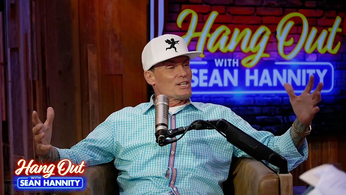 Vanilla Ice speaking on a podcast while sitting in front of a microphone.