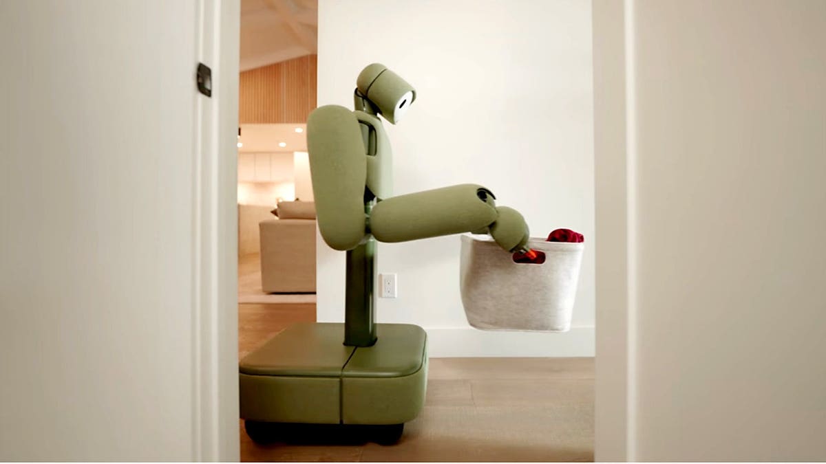 Weave Robotics’ Isaac 1 home robot carries a basket through a home's hallway.