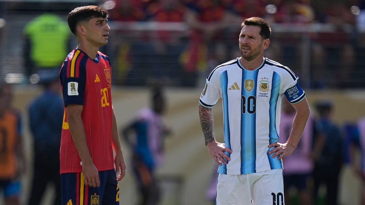 Lionel Messi looks on