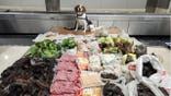 CBP K9 Maisy with seized luggage contents