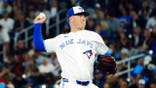 Braydon Fisher pitches during a game at Rogers Centre.