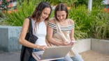 College students look at laptop