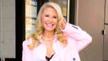Christie Brinkley wearing a pink blazer smiling in New York City.