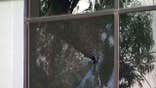 Screen grab of FOX 10 video showing ICE field office window with bullet holes