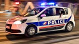 French police officers drive a car in Paris.