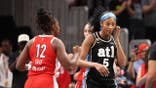 Angel Reese reacts against Chelsea Gray during a game in Atlanta.