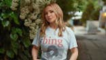 Hayden Panettiere posing outdoors while promoting her new memoir.