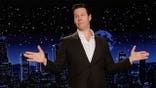 Ike Barinholtz stands on a stage at Jimmy Kimmel Live!