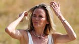 Jena Sims Koepka walks on a golf course.