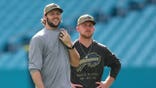 Josh Allen and Joe Brady looking on before a game