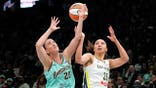 Sabrina Ionescu fights for the ball with Azzi Fudd during a WNBA game in New York.