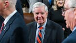 Lindsey Graham walks at the Capitol in Washington, D.C.