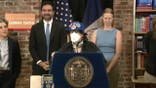 Mamdani stands behind woman at press conference
